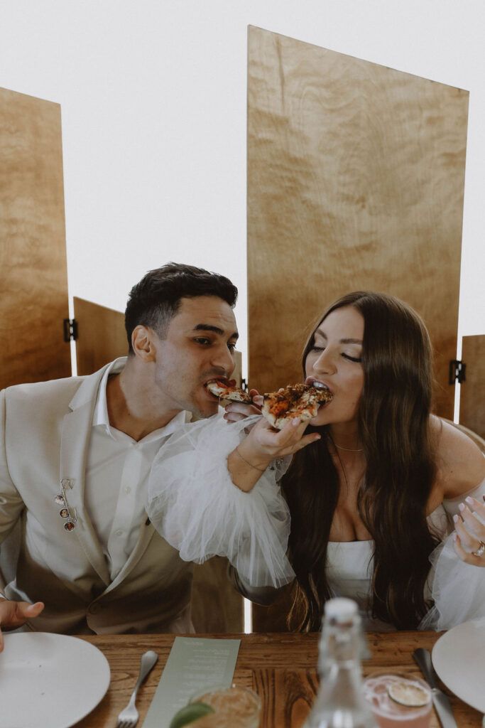 Bride and groom eating pizza at French Oak Ranch wedding reception 