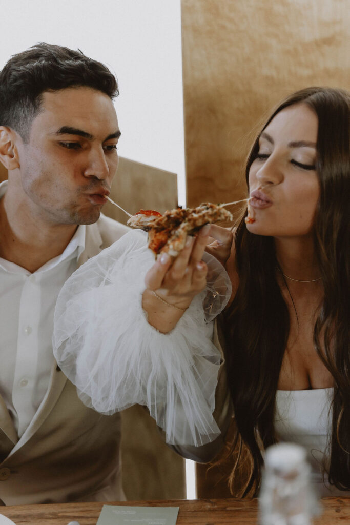 Bride and groom eating pizza