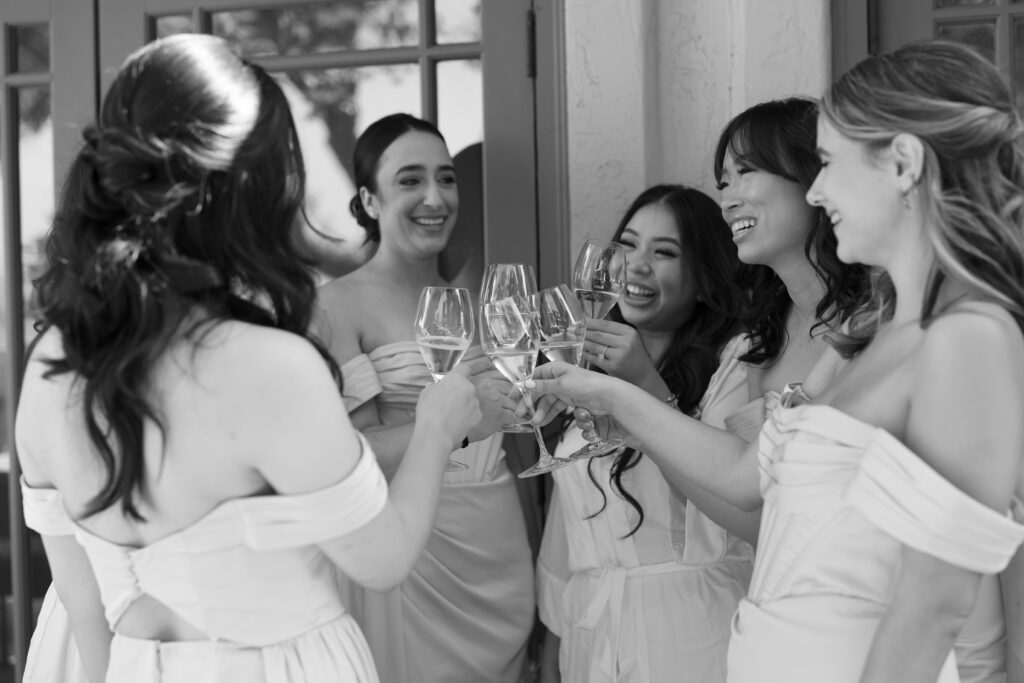 Bride and bridesmaids toasting wine