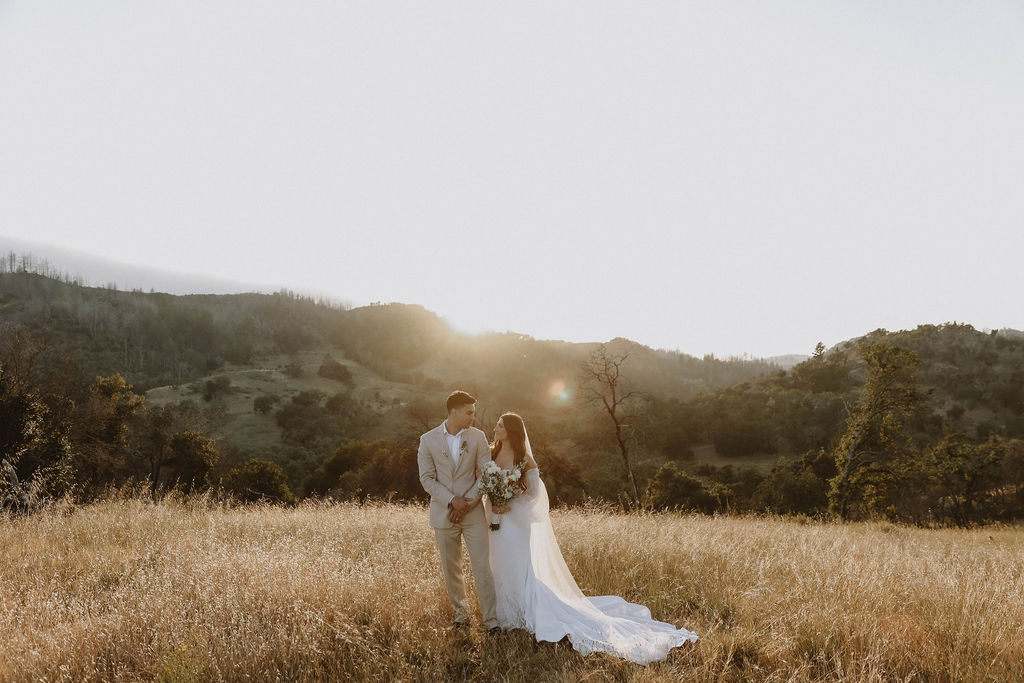 West Event Co | Sonoma County Wedding Planner | couple on their wedding day looking at each other with the sun in the background